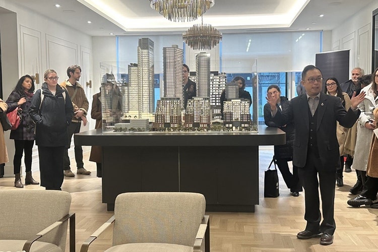 This photo, taken by Nicole Lechter, shows a model of a master-planned community as one of the executives speaks to a room of people about the project.